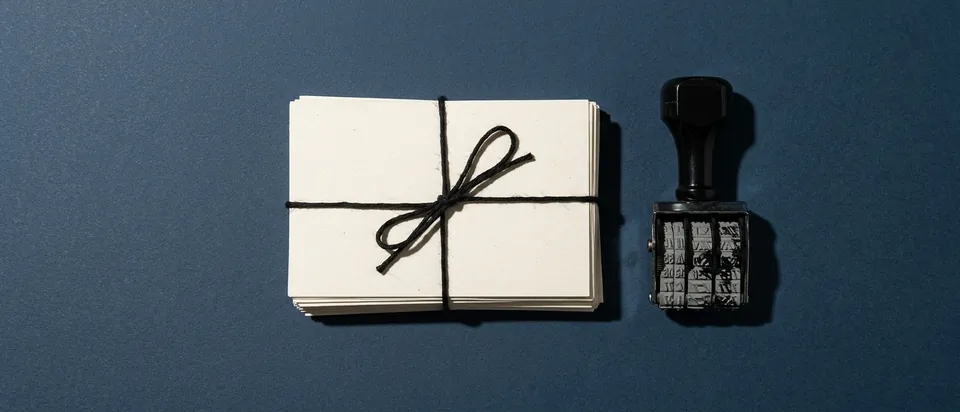 A bundle of question cards and a date stamp on a slate background