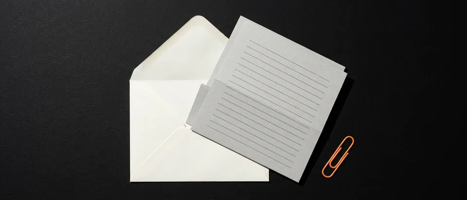 An opened letter in its envelope on a black background, like a notice from an internet provider