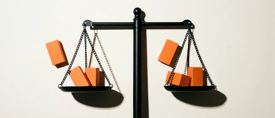A balance scale holding four blocks, standing for the four fair use factors